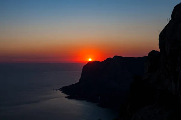 silhouette of the bay coast at red sunset view from the top with clear sky