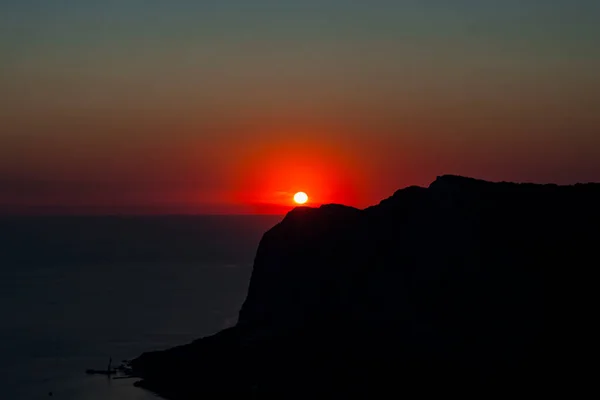 silhouette of the bay coast at red sunset view from the top with clear sky