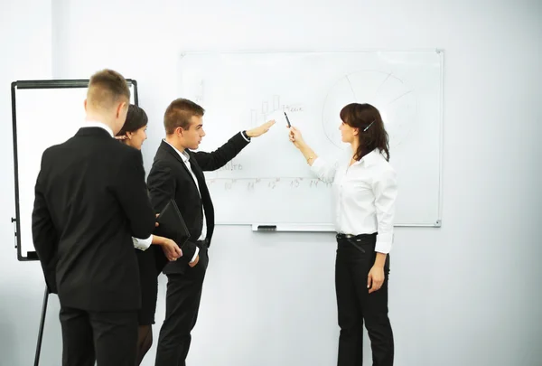 Businesswoman giving a presentation to business team — Stock Photo, Image