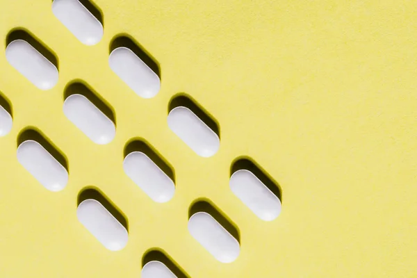 Close up. lot of pills on a yellow background. — Stock Photo, Image