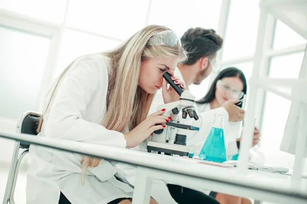 Close up. a group of scientists conduct research in a modern lab — Stock Photo, Image