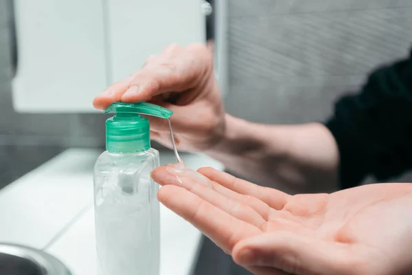 Close up. man puts liquid soap on his hands . — Stock Photo, Image