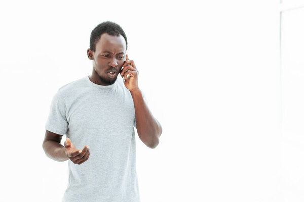 Serious young man talking on his smartphone. photo with copy space