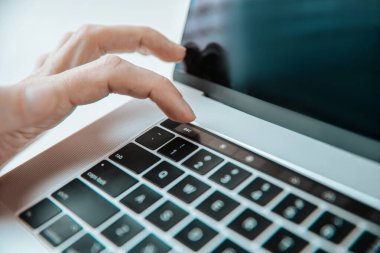 Kapat. Adam dizüstü bilgisayarında dokunmatik klavye kullanıyor..