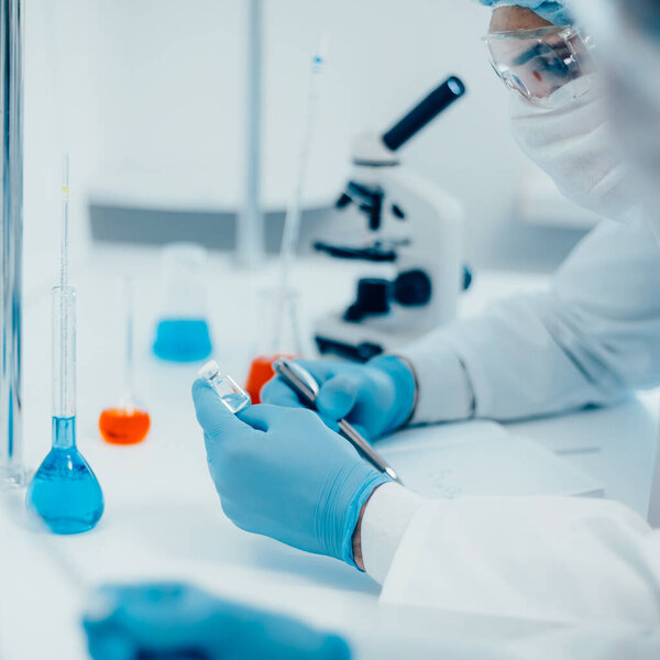 close up. a scientist writing down the formula for a new drug .