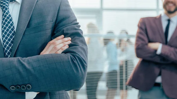 Confident business man standing in a modern office — Stock Photo, Image