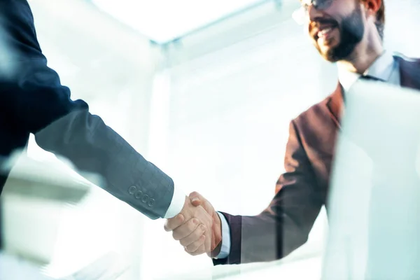 Bottom view. handshake of business partners over the Desk — Stock Photo, Image