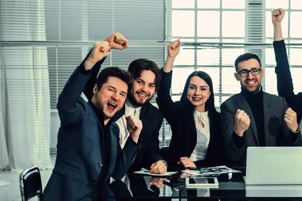 Large business team showing their success while sitting at their Desk — Stock Photo, Image