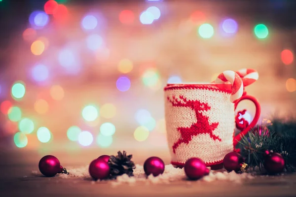 Tazza per tè o caffè con decorazioni natalizie a maglia e decorazioni natalizie su sfondo festivo — Foto Stock