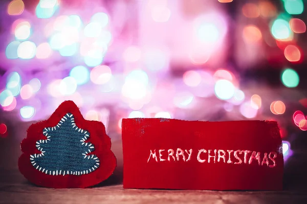 Inscription merry Christmas on a festive blurred background . — Stock Photo, Image