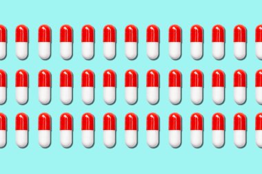 Mavi arka planda üç sıra tıbbi kapsül..