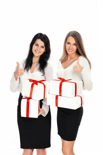 Two young women with gift boxes showing thumbs up — Stock Photo, Image