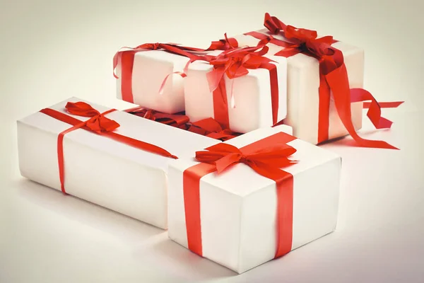 Stack of red gift boxes decorated with bow isolated on white — Stock Photo, Image