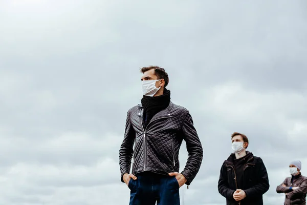 People in protective masks standing at a safe distance — Stock Photo, Image