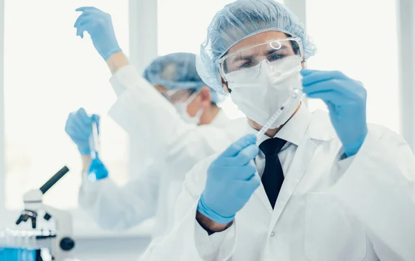 background image of a laboratory assistant in a medical laboratory