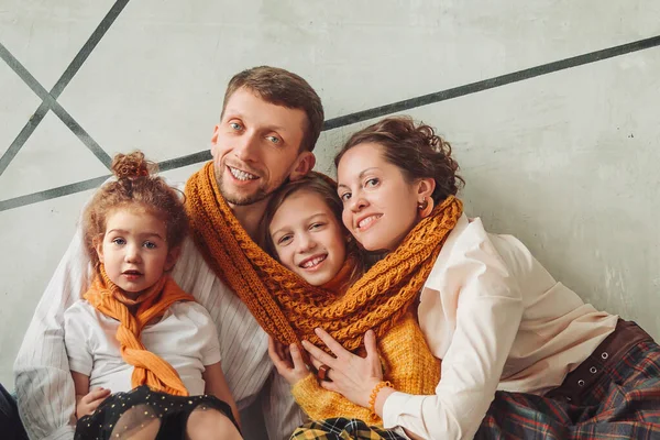Happy family sitting on the floor in new apartment. — Stock Photo, Image
