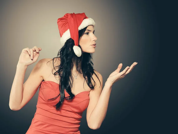 Woman in costume of Santa Claus showing to copy space — Stock Photo, Image