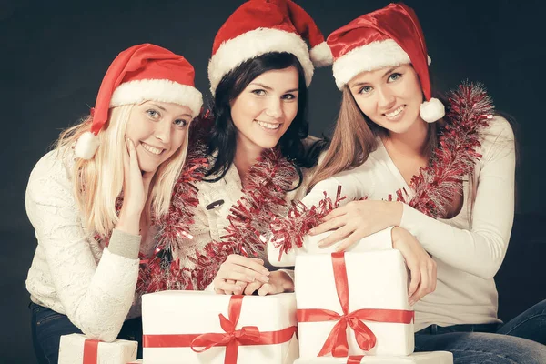Group of happy women in costumes of Santa Claus and Christmas shopping . — Stock Photo, Image