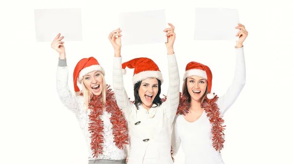 Grupo de estudantes do sexo feminino em trajes de Papai Noel segurando folhas em branco — Fotografia de Stock