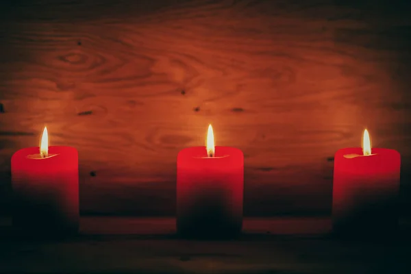 Candles on the old wooden background with shading around the edges. holiday concept — Stock Photo, Image