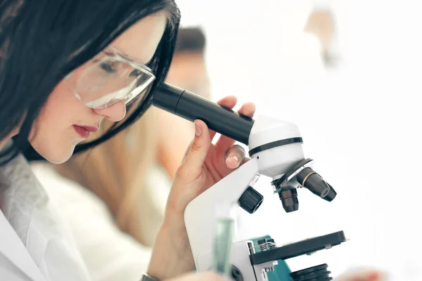 close up.the scientist looks into the microscope in the laborato