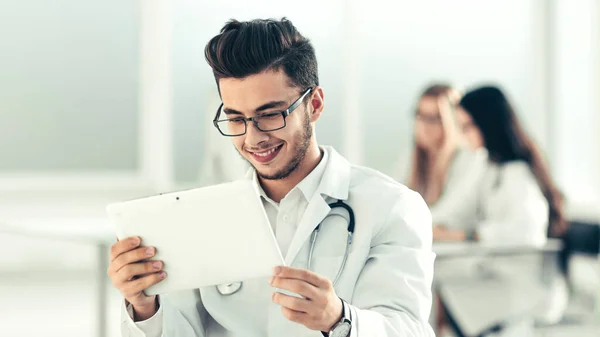 Leende läkare tittar på den digitala tablettskärmen — Stockfoto