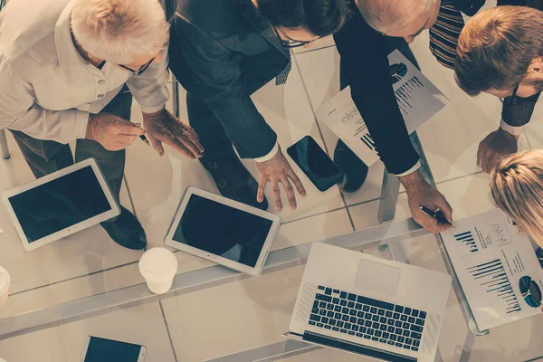 top view. group of employees analyzing financial performance .