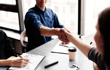 Kapat. Genç iş adamları el sıkışıyor..