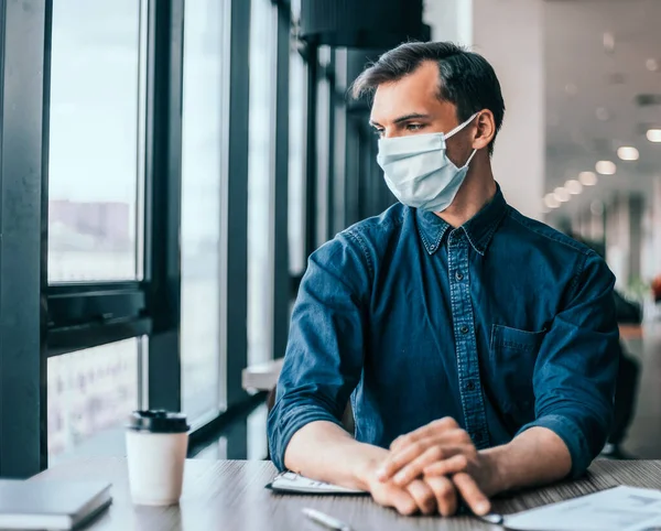 business colleagues in protective masks working with financial documents.