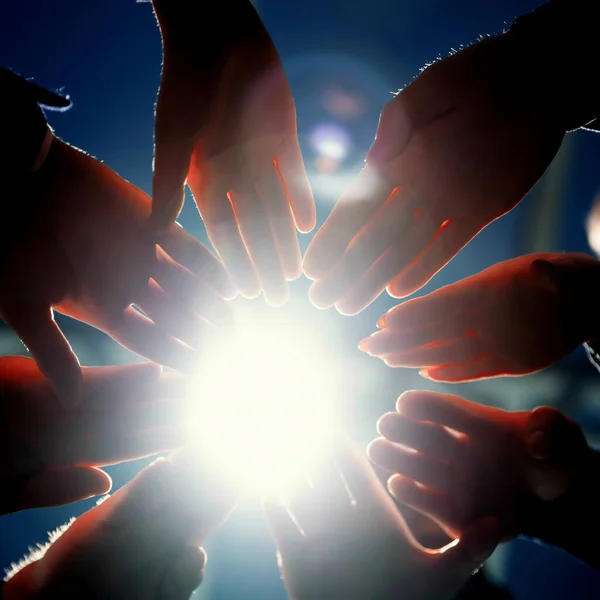 Close up. young business people joining their palms in a circle. — Stock Photo, Image