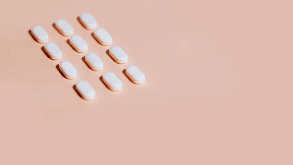 Tablets on a white sheet of paper. — Stock Photo, Image