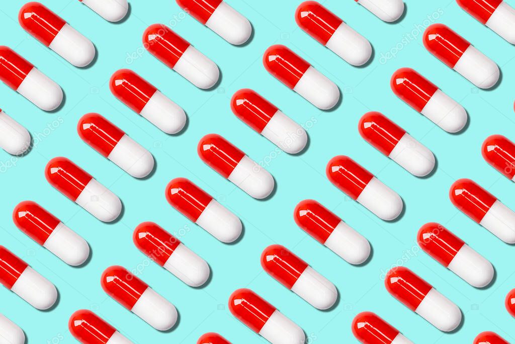 three rows of medical capsules on a blue background.