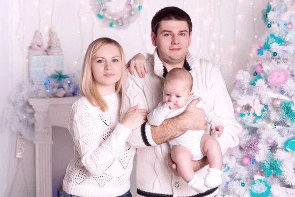 Happy family standing by the Christmas tree — Stock Photo, Image