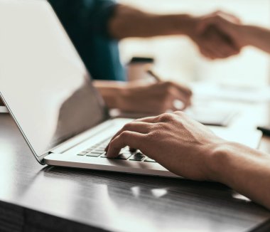 Kapat. İşadamı ofiste dizüstü bilgisayarla çalışıyor..