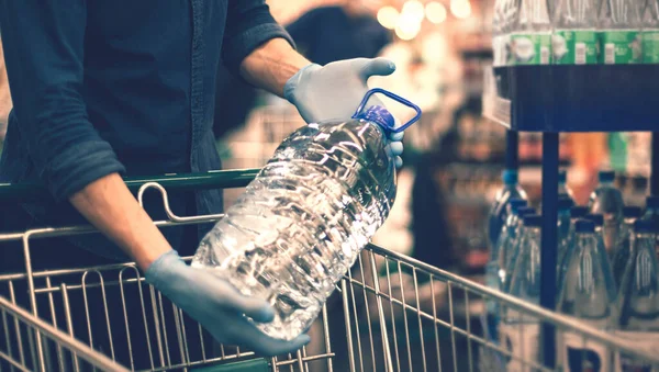 Close up. a man with a bottle of drinking water — Stock Photo, Image