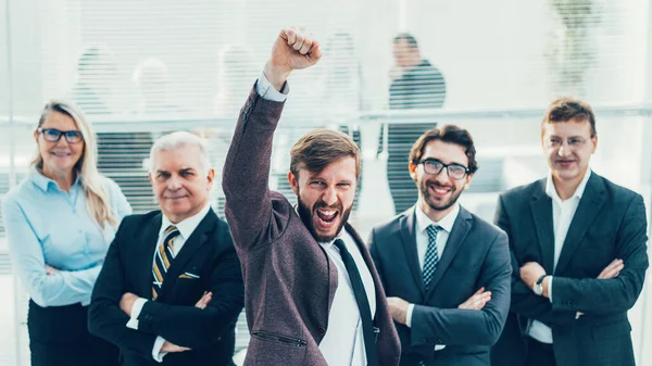Very happy businessman standing in front of his business team — Stock Photo, Image