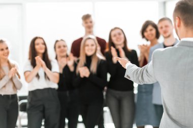 Konferans odasında duran bir grup farklı insanın bulanık görüntüsü.