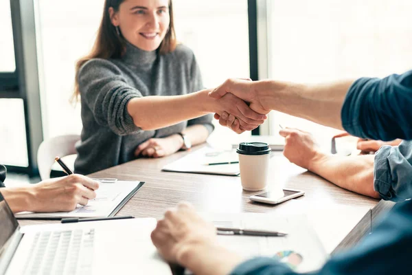 Close up. smiling business woman shaking hands with her colleague . — Stock Photo, Image