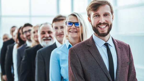 Young business man standing in line for an interview — Stock Photo, Image