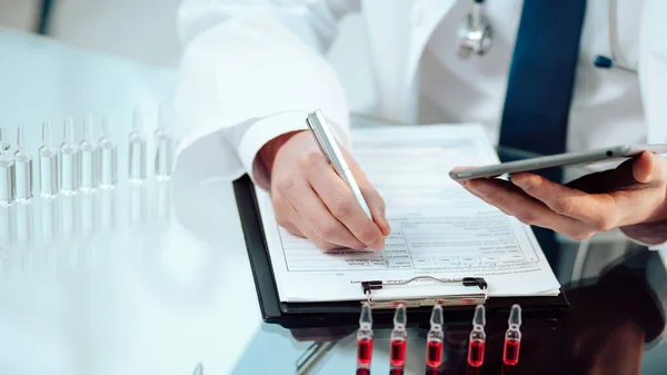 scientific laboratory assistant recording the results of a vaccine study.