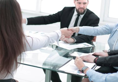 Meslektaşlar el sıkışarak işi onaylıyorlar.