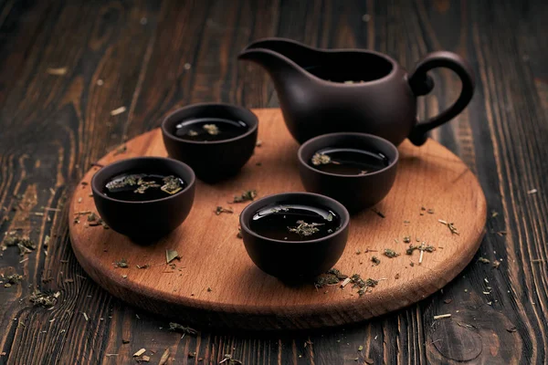 Tea set and tea leaves on wooden kitchen board. Stock Image