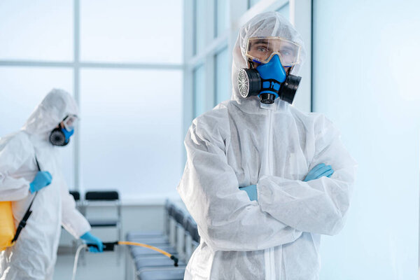 team of professional disinfector standing in the hospital lobby .