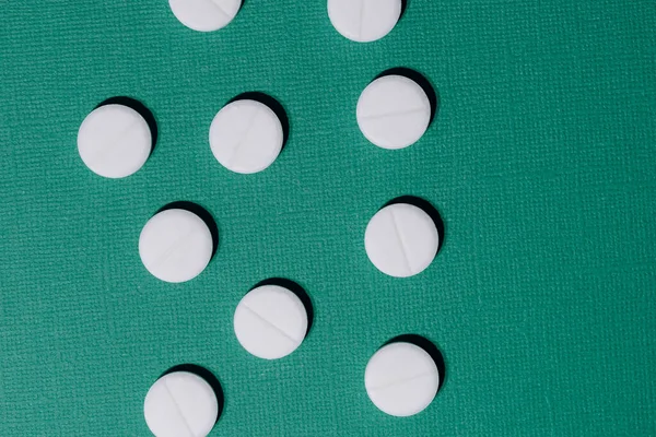 Close up. lot of pills on a dark green background. — Stock Photo, Image