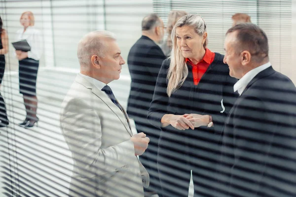 business colleagues talking standing in the office