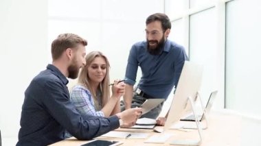 business people discussing work documents in the office .
