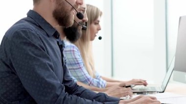call center employees at the workplace in the office .