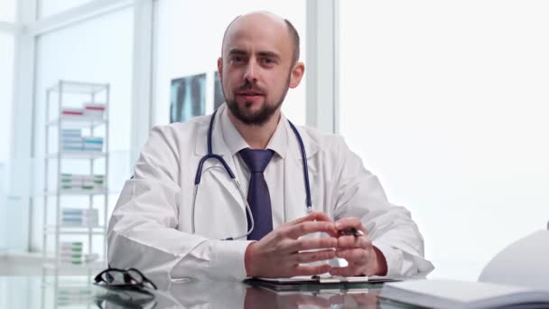 Doctor is consulting his patient and checking the medical record . — Stok Video