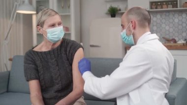 mature woman getting an injection in her forearm.
