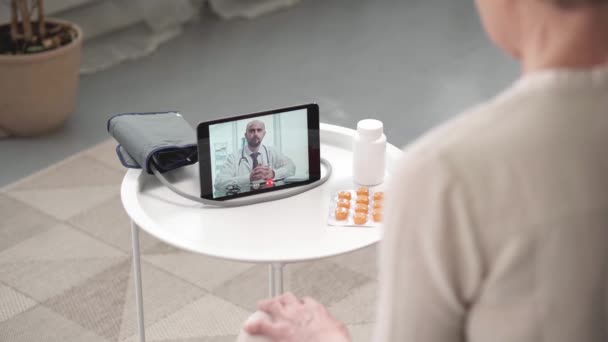 Žena používající digitální tablet pro online konzultaci se svým lékařem. — Stock video